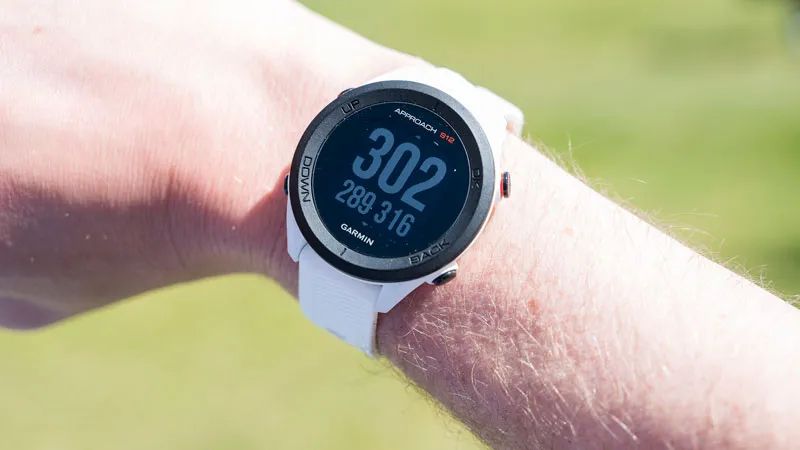 Garmin S12 watch in white on golfers wrist