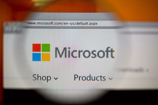 A magnifying glass focussing on the Microsoft logo on a web browser
