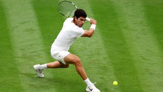 Carlos Alcaraz of Spain plays a backhand against Jeremy Chardy of France in the Men's Singles first round match during day two of The Championships Wimbledon 2023 at All England Lawn Tennis and Croquet Club 