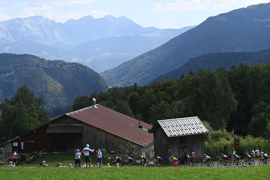 MORZINE LES PORTES DU SOLEIL FRANCE JULY 15 A general view of Jonas Vingegaard of Denmark and Team JumboVisma Yellow leader jersey and Tadej Pogacar of Slovenia and UAE Team Emirates White best young jersey and the peloton passing through a landscape during the stage fourteen of the 110th Tour de France 2023 a 1518km stage from Annemasse to Morzine les Portes du Soleil UCIWT on July 15 2023 in Morzine les Portes du Soleil France Photo by Tim de WaeleGetty Images