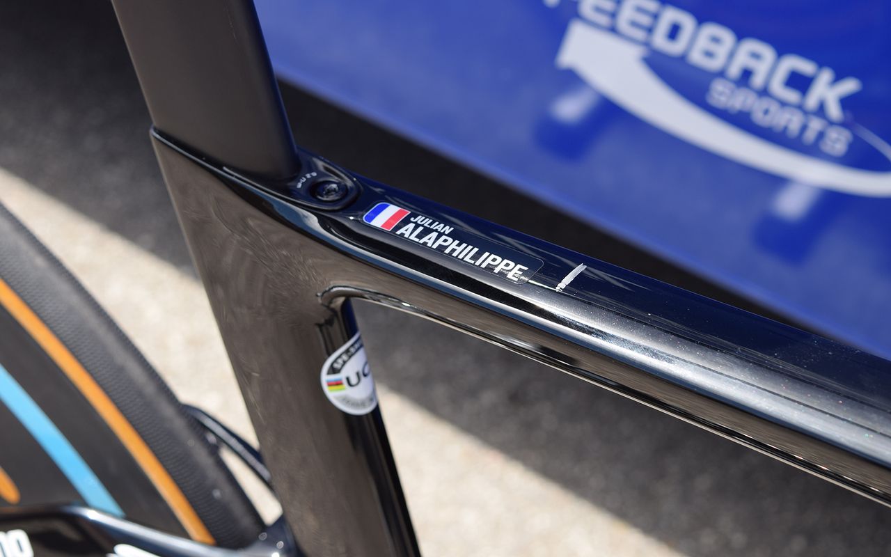 A small name decal sits on the top tube of the frame