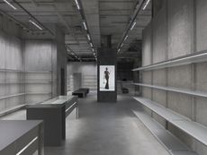 Inside empty Balenciaga store with concrete walls and fixtures