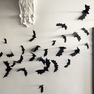 Cardboard cut out bats on a white hallway wall