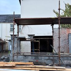 the exterior of a house renovation with scaffolding and breezeblocks