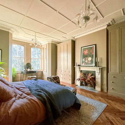 large bedroom with period details and marble fireplace