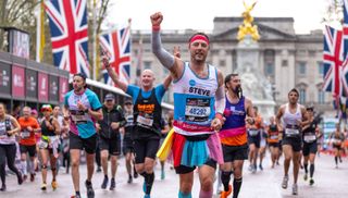 Participants wearing fancy dress celebrate as they run down The Mall toward the finish line during The TCS London Marathon on Sunday 23rd April 2023.