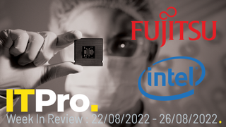 A researcher holding a computer chip in front of their face, with the Fujitsu and Intel logos displayed to the side
