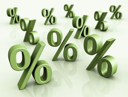 3D green percent signs on a table