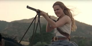 Dolores shooting and riding a horse