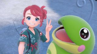 A pink-haired Pokémon trainer taking a selfie with a Politoed.