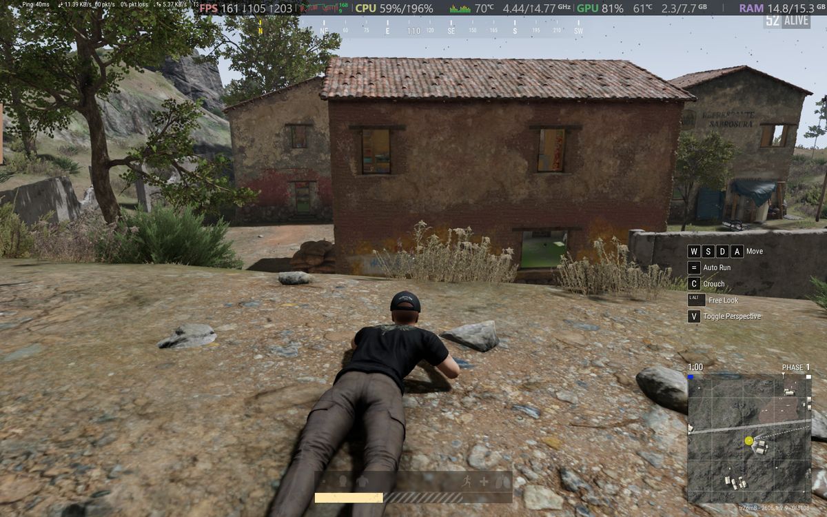 PUBG gameplay screenshot showing third person prone position and UI elements running on an Alienware 15 laptop