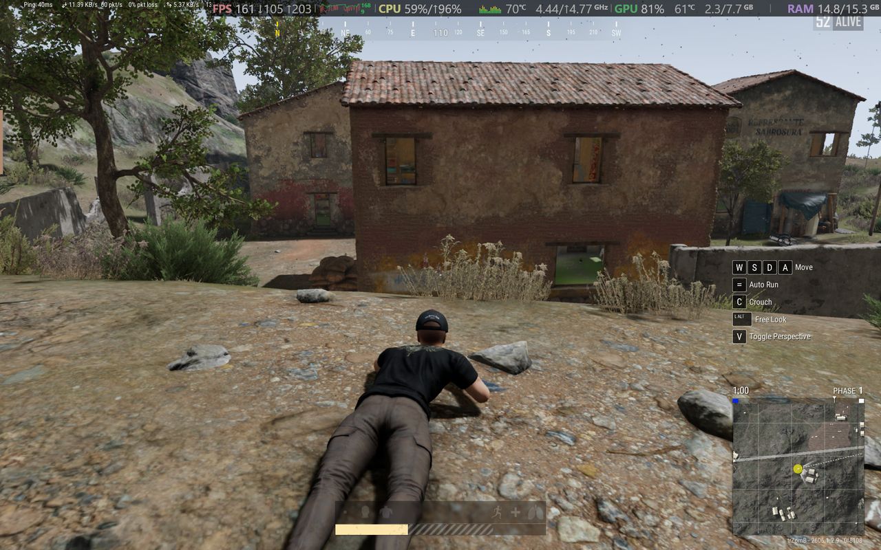 PUBG gameplay screenshot showing third person prone position and UI elements running on an Alienware 15 laptop