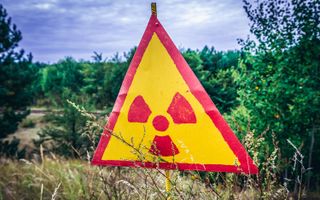 A radioactive warning sign inside the exclusion zone.