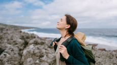 Woman looking away from the sea on hiking trip