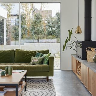 living room with green sofa and glass sliding doors
