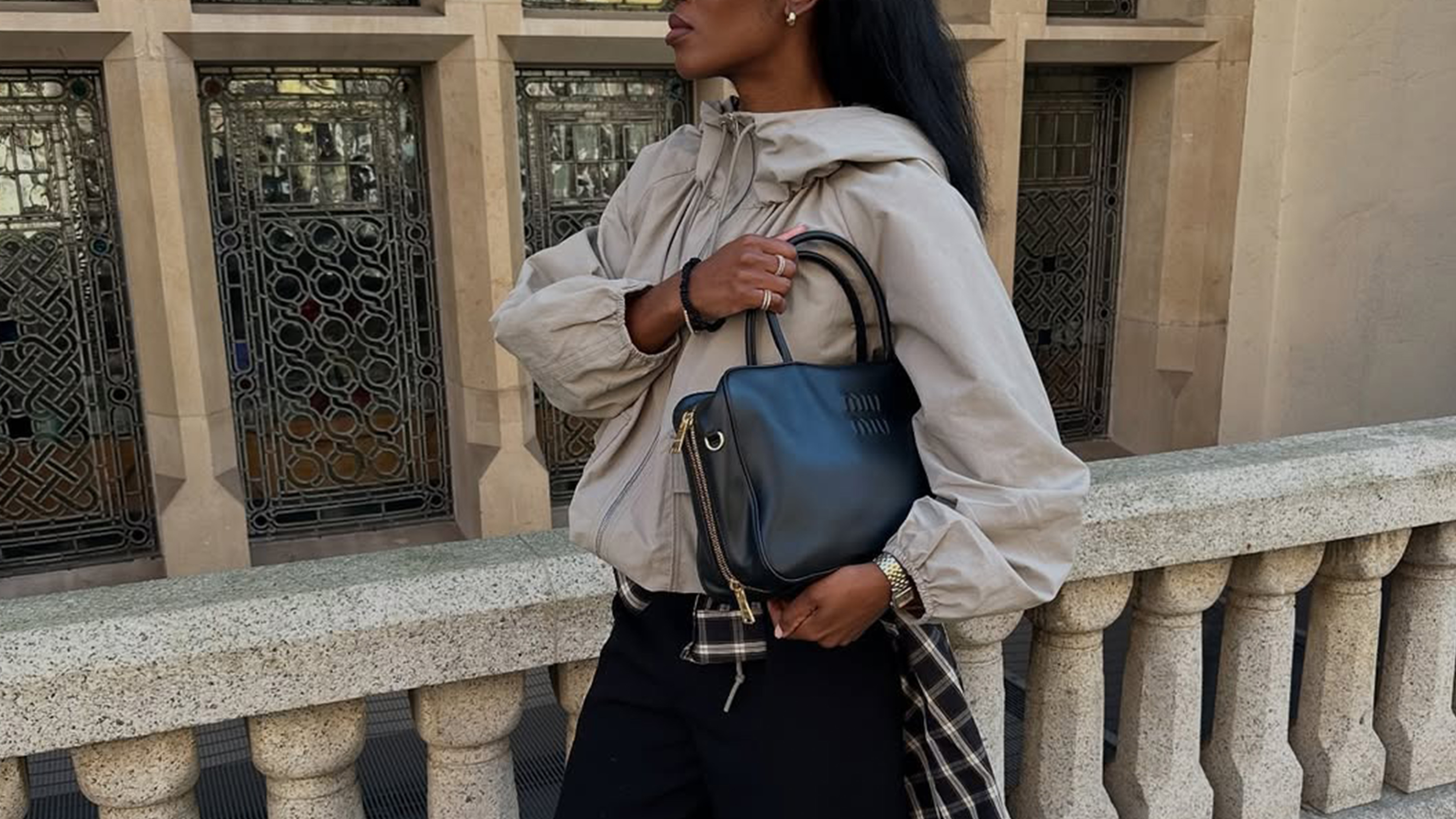 woman wearing windbreaker and flannel shirt