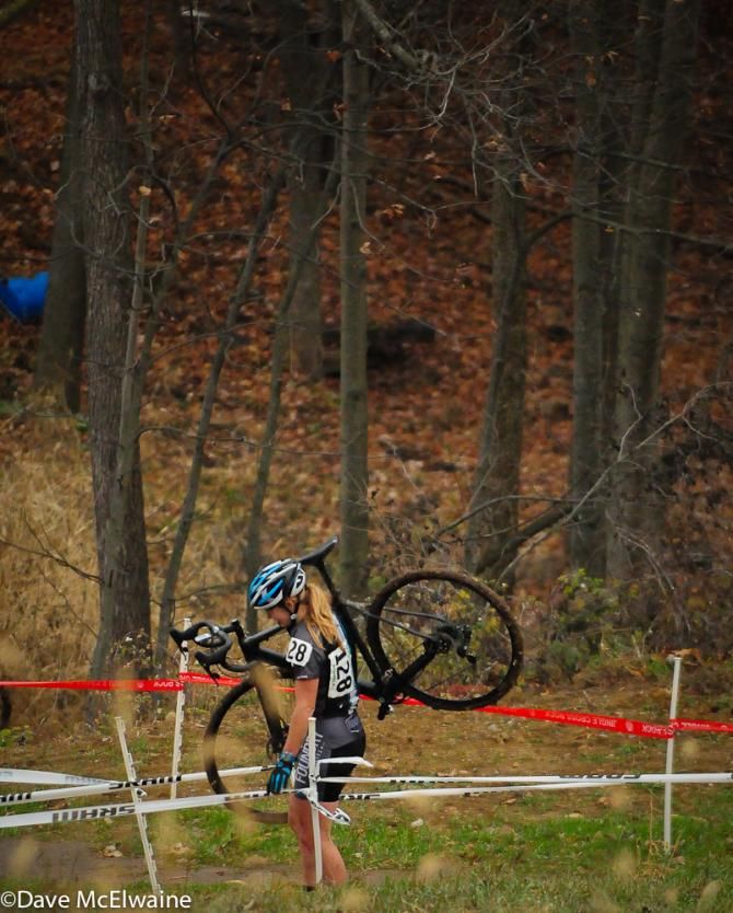 April Morgan (Foundry Cycles) hiking out of the woods after apparently suffering a mechanical