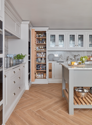 Grey cabinets and kitchen island with wooden shelves