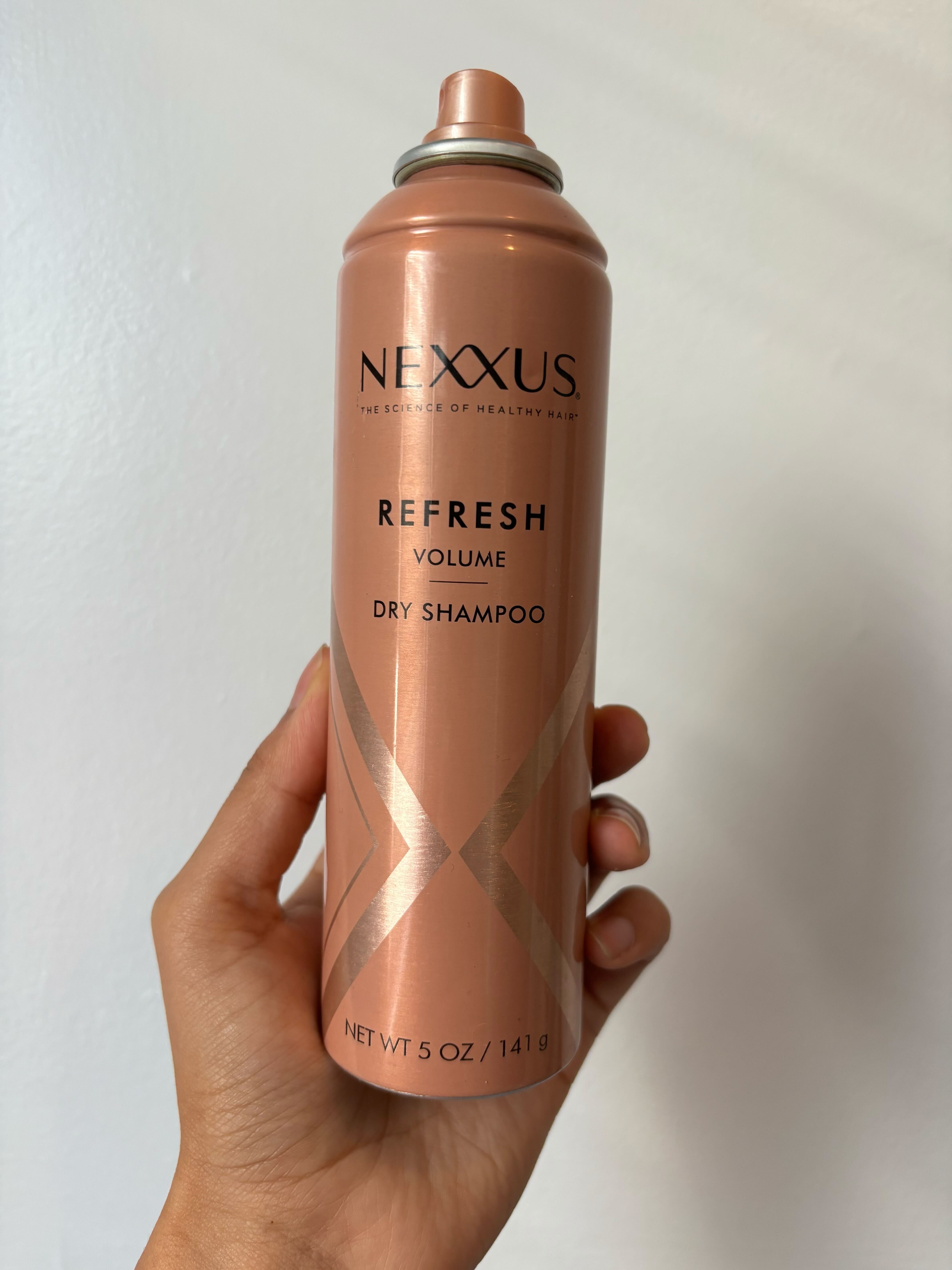 Assistant beauty editor Sabrina Talbert holding Nexxus Refresh Volume Shampoo.