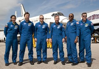 The last crew of shuttle Discovery, the STS-133 astronauts, poses for a photo in front of on the Shuttle Landing Facility's Runway 15 at NASA's Kennedy Space Center in Florida after landing on March 9, 2011.