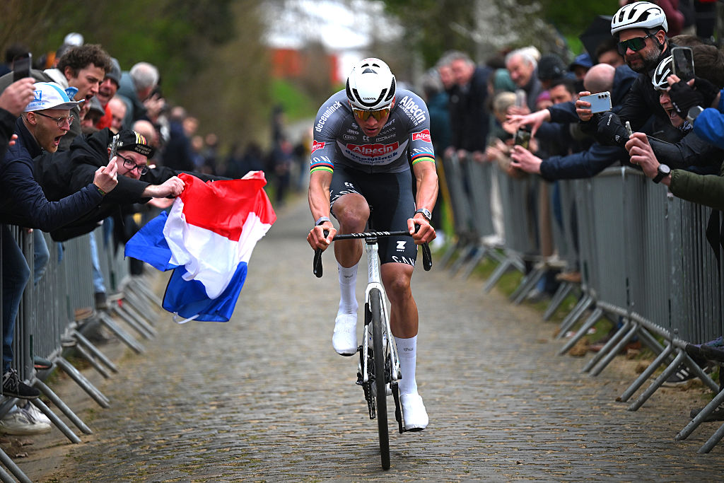 HARELBEKE, BELGIUM - MARCH 28: Race winner Mathieu Van Der Poel of Netherlands and Team Alpecin - Deceuninck competes passing through the Oude Kwaremont cobblestones sector while fans cheer during the 68th E3 Saxo Bank Classic - Harelbeke 2025 a 208.8km one day race from Harelbeke to Harelbeke / #UCIWT / on March 28, 2025 in Harelbeke, Belgium. (Photo by Tim de Waele/Getty Images)