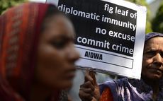 An Indian woman protests diplomatic immunity for Majed Hassan Ashoor.