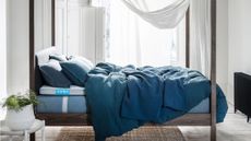 simba mattress deal: bed with simba mattress and dark wood frame and blue bedding