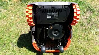 Underside of Segway Navimow robot mower on grass