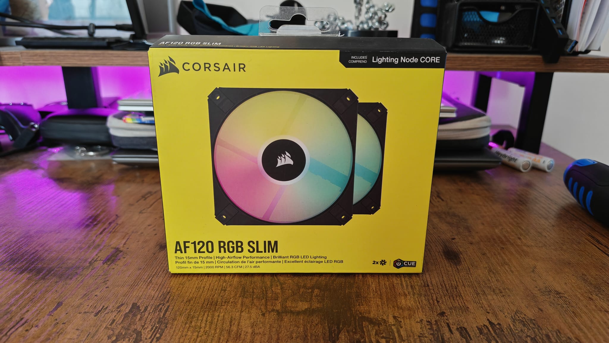 The box for some Corsair AF120 RGB fans on a gaming desk