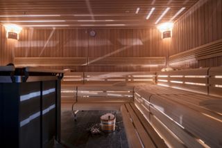 image of sauna, pale wooden seating and walls