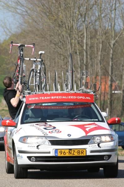 The Specialized team mechanic working on a bike on the go