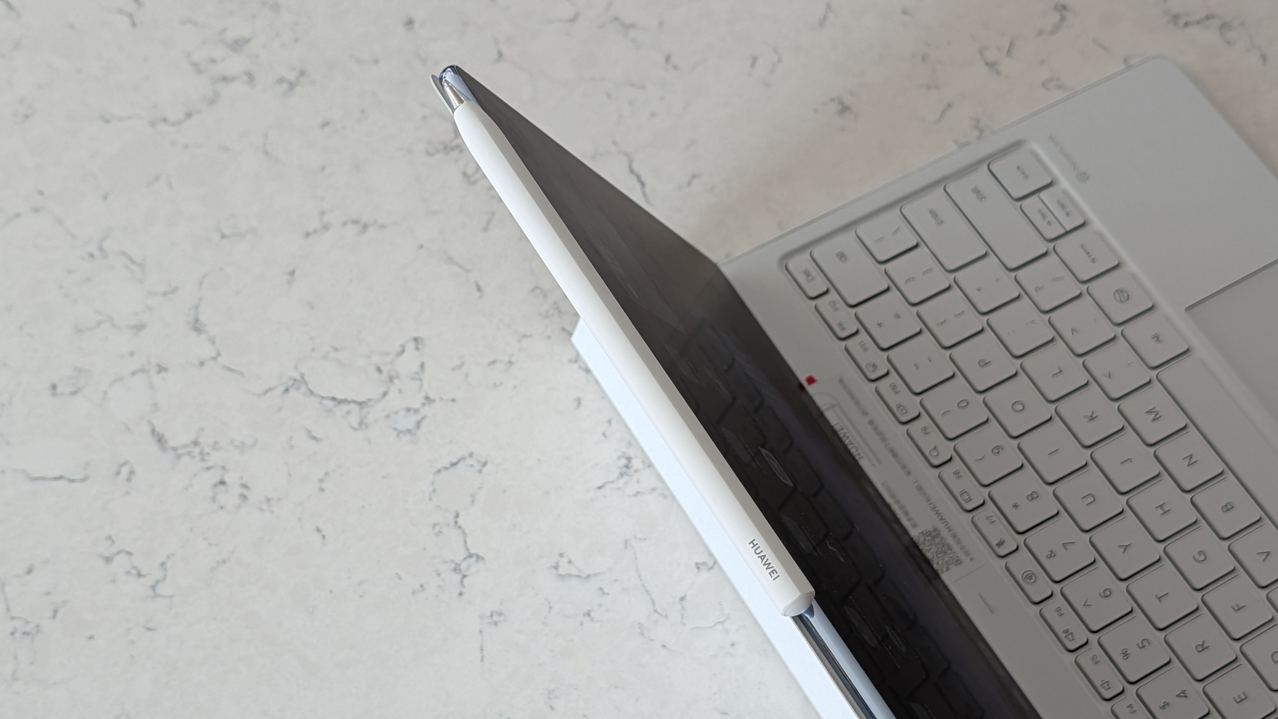 Photos of the Huawei MatePad Pro Max resting on a marble table
