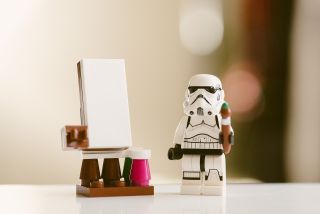 A lego storm trooper stands next to blank presentation page.