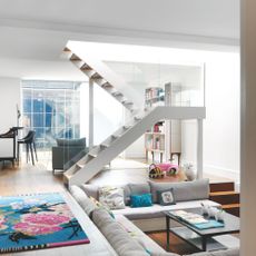 basement living room, with sunken seating area and half turn staircase
