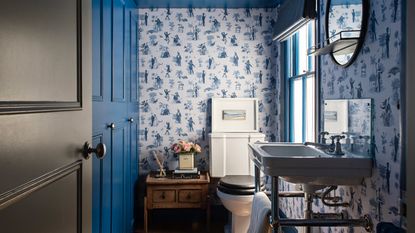 blue small bathroom ideas, blue toile style wallpaper, blue walls and ceiling, trad basin, vintage side table, stripe blind