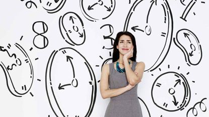 A woman surrounded by drawings of clocks