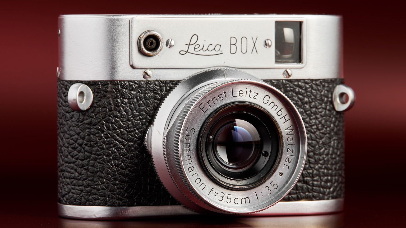 The working Leica Box camera prototype from the mid 1950s on a red background