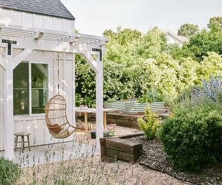 Maximalist yard design with swing chair