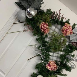 Door frame decorated with green garland