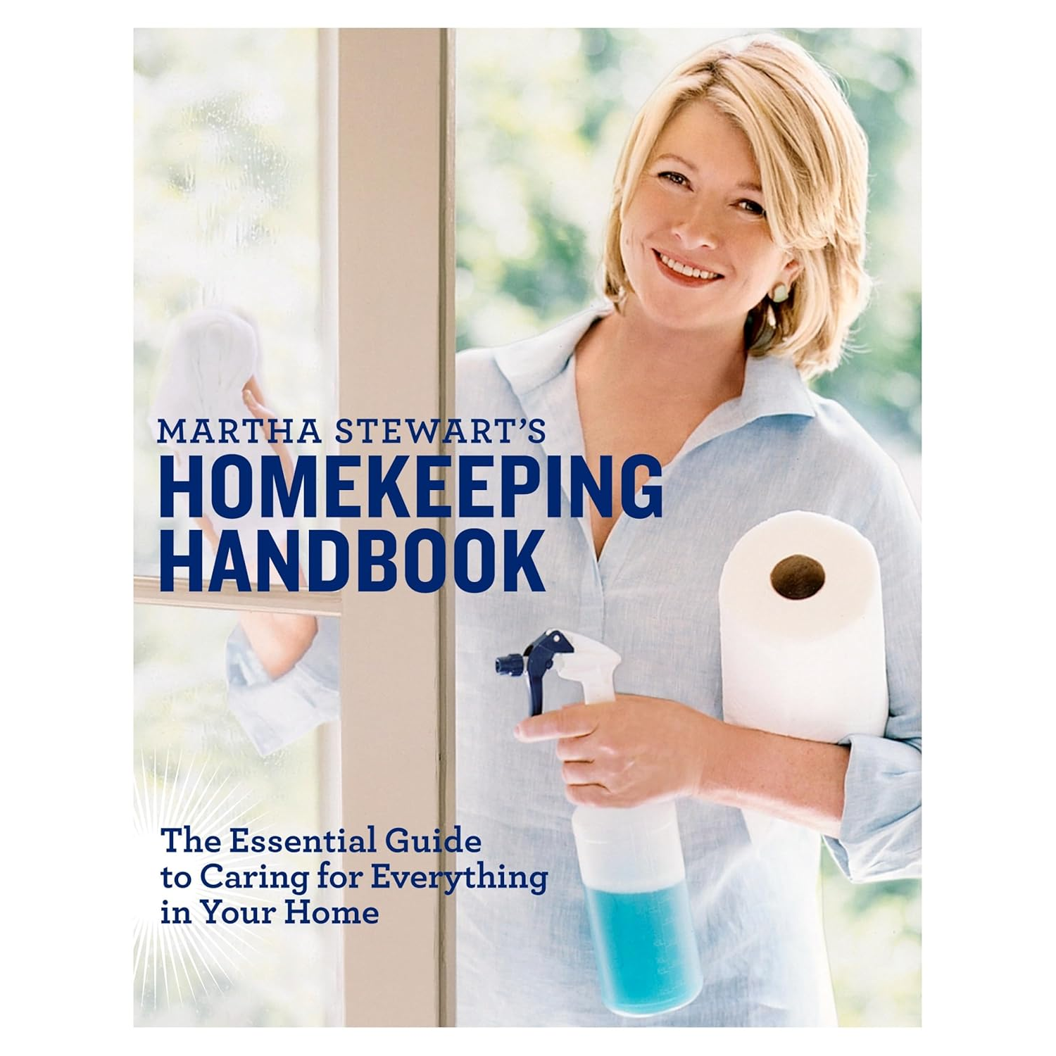 A hardcover book cover titled 'Martha Stewart's Homekeeping Handbook' witha picture of Martha holding a kitchen roll and a spray bottle