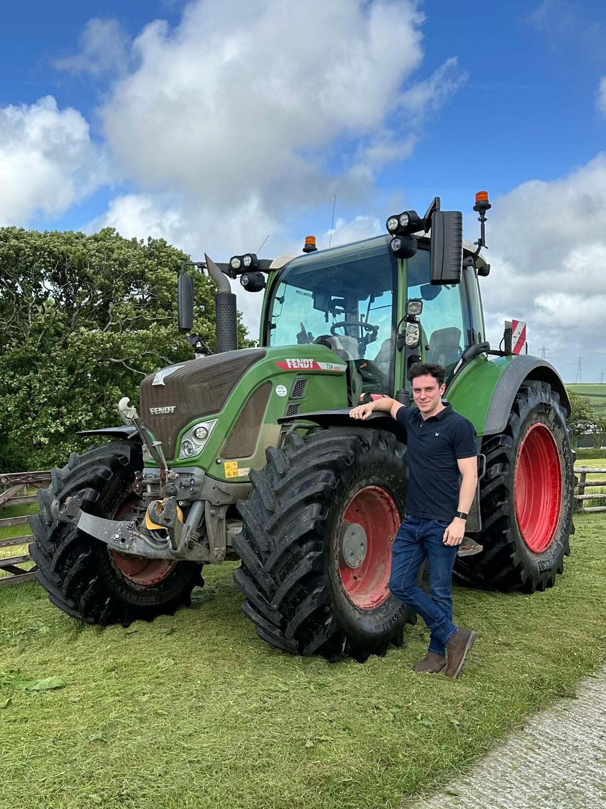 The racing driver Alex Quinn next to his tractor