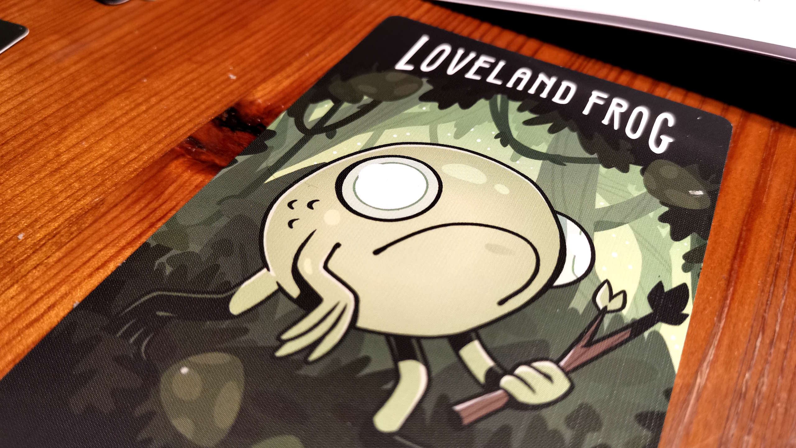 Twisted Cryptids card on a wooden surface