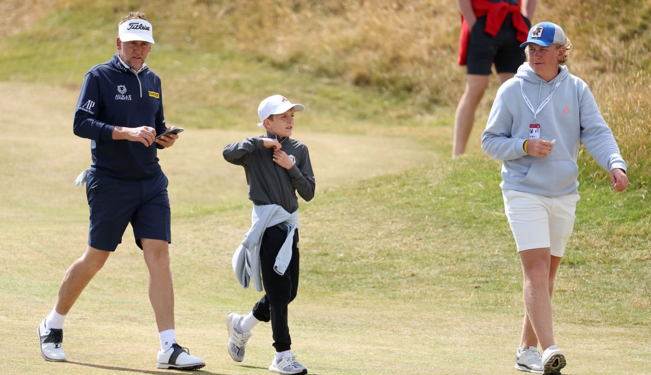 Ian Poulter walks alongside his son Josh and Luke during The 150th Open Championship