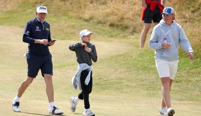 Ian Poulter walks alongside his son Josh and Luke during The 150th Open Championship