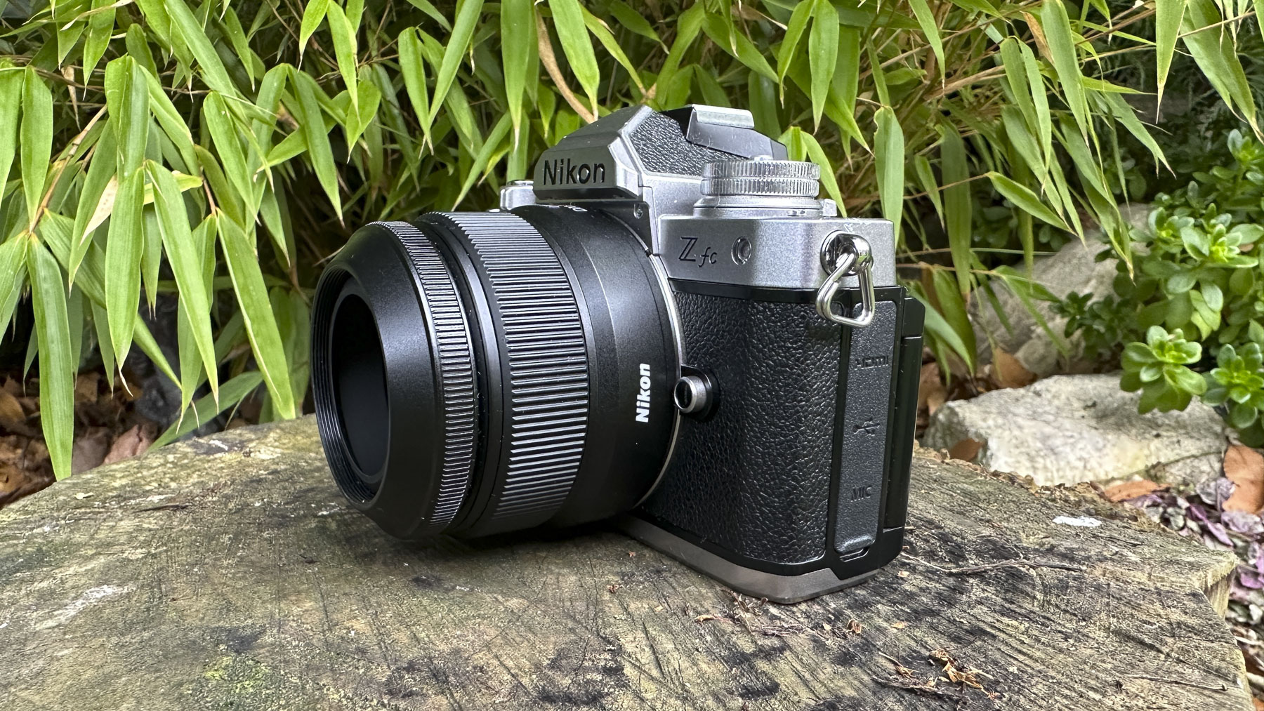 Nikkor Z DX 24mm f/1.7 lens side view with the lens mounted on a Nikon Z fc camera