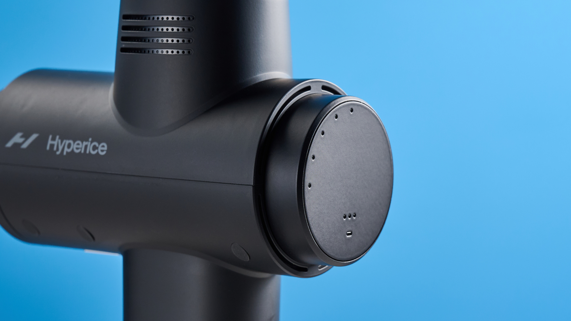 the hyperice hypervolt 2 pro massage gun with a long ergonomic handle and interchangeable massage head attachments