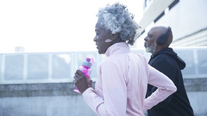 Two seniors exercising outside