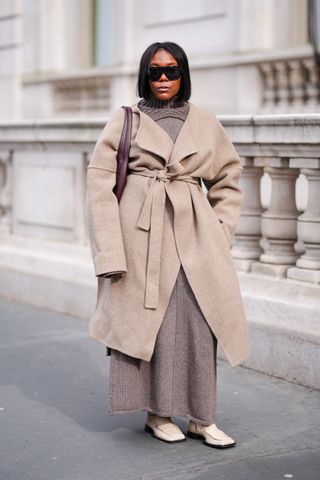 Woman in knit dress and camel coat