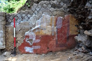 The building's colorful wall paintings are gradually being conserved and put back together.