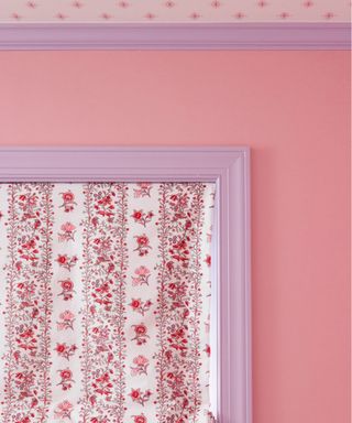 pink wall with lilac window frame and picture rail, red and white floral window blind